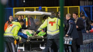 Medics transport Russian goalkeeper Igor Akinfeev after was hit by a flare thrown from the stands during the Euro 2016 Group G qualifying soccer match between Montenegro and Russia, at the City Stadium in Podgorica, Montenegro, Friday, March 27, 2015. (AP Photo/Risto Bozovic)